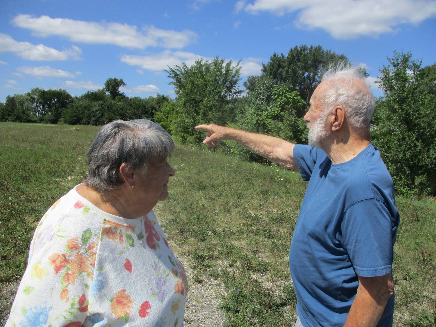 Allen Winter with his wife, Susan, points to where her family home once stood on the Joliet land that once was a farm and now is set to be developed into a gas station. Aug. 30, 2023.