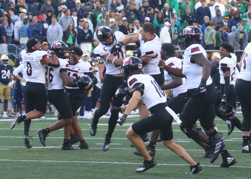 Members of the NIU football team celebrate after beating Notre Dame on Saturday, Sept. 7, 2024 at Notre Dame Stadium.