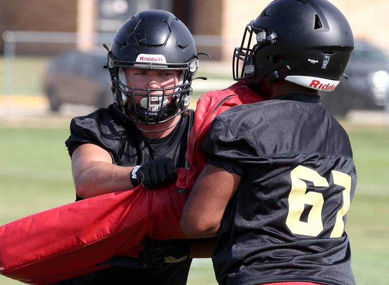 Sycamore’s Owen DePauw (left) blocks during a drill Monday, Aug. 12, 2024, at the first practice of the regular season.