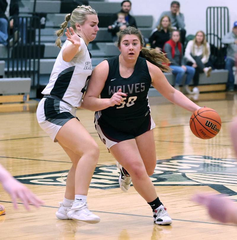 Prairie Ridge's Grace Wolf tries to get around Kaneland's Berlyn Ruh Thursday, Feb 15, 2024, during their Class 3A regional final game at Kaneland High School in Maple Park.