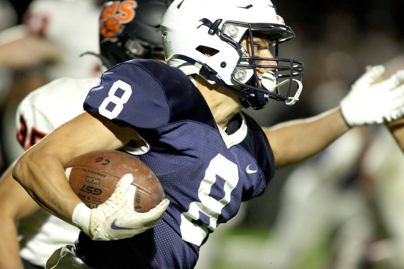 Cary-Grove’s Andrew Prio runs the ball against Libertyville  in first-round Class 6A playoff  football action at Cary Friday.