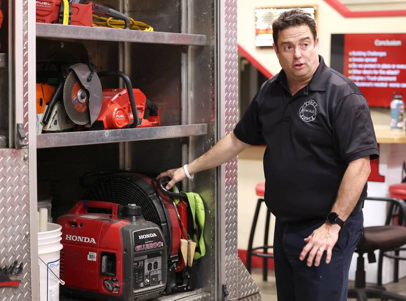 DeKalb firefighter/paramedic Pat Eriksen talks Wednesday, April 17, 2024, at the DeKalb Fire Department Fire House No. 1, about the gear the truck he drives carries on board.