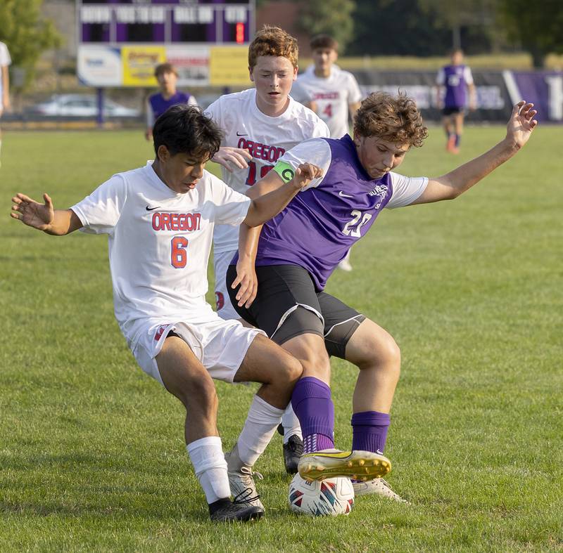 Dixon’s Jayvian Herwig works against Oregon’s Eduardo Munzo Garcia for the ball Wednesday, Sept. 11, 2024, at EC Bowers field in Dixon.