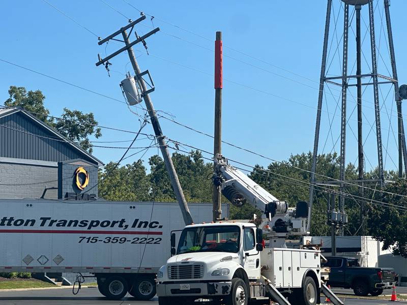 Crews from ComEd worked Wednesday, Sept. 4, 2024, to repair a power pole and wires in downtown Richmond after a semitrailer clipped it earlier in the day.