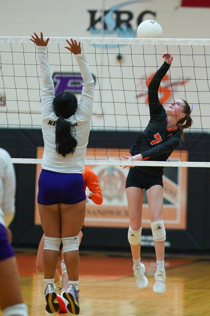 Sandwich's Liza Goodbred (7) goes up for a kill attempt against Plano's Chloe Rowe (16) and Camila Nunez (15) during a volleyball match at Sandwich High School on Tuesday, Sep 10, 2024.