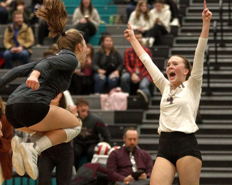 Prairie Ridge’s Alli Rogers, right, and Grace Jansen, left, erupt as they win against Woodstock in IHSA Class 3A sectional semifinal volleyball action at Woodstock North Monday.