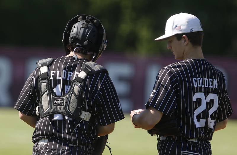 Prairie Ridge's Vic Flores talks with pitcher Riley Golden during a Class 3A Deerfield baseball regional game against Deerfield on Wednesday, May 22, 2024, at the Deerfield High School.