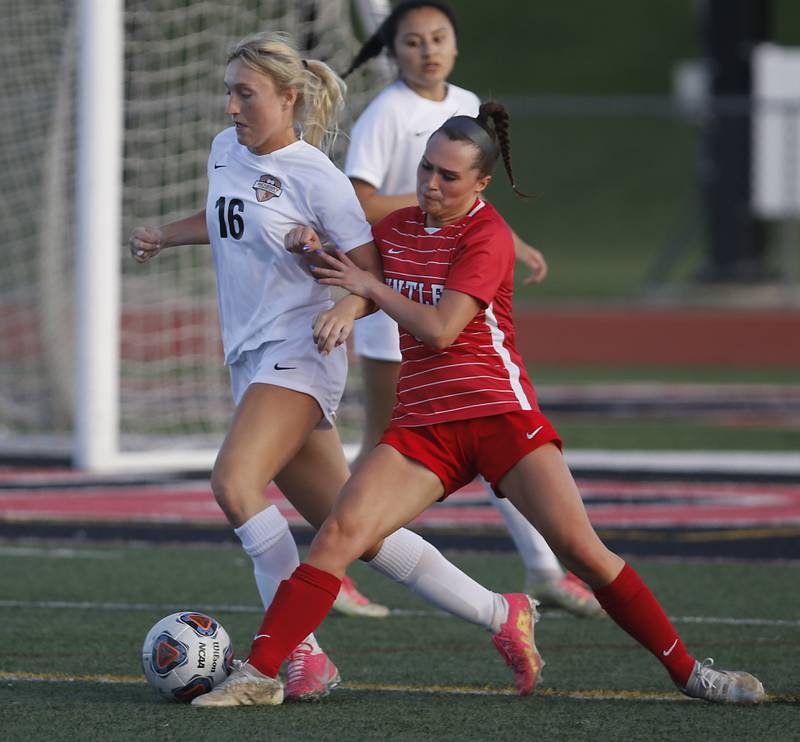 McHenry's Sarah Duginske is pushed by Huntley’s Grace Helzer as she tries gain possession of the ball during a Fox Valley Conference soccer match Thursday, April 13, 2023, at Huntley High School.