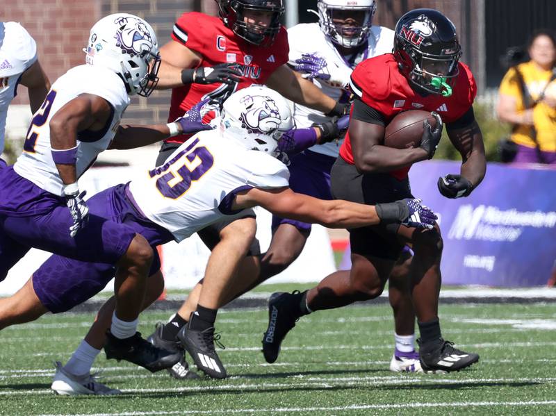 Northern Illinois' Antario Brown runs away from Western Illinois' Ryan Crandall during their game Saturday, Aug. 31, 2024, in Huskie Stadium at NIU in DeKalb.