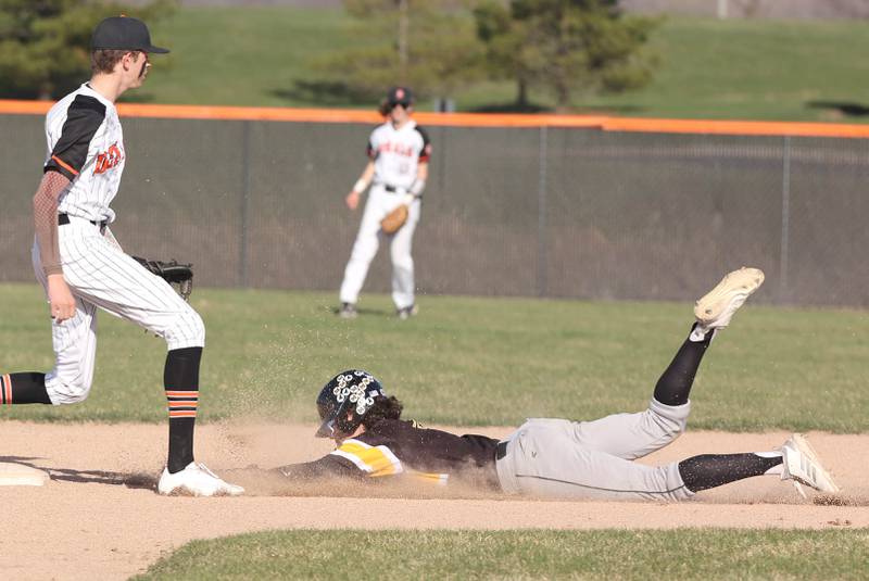 Metea Valley's Jeremy Wrona slides safely into second base as the ball gets by DeKalb's Jackson Kees during their game Thursday, April 13, 2023, at DeKalb High School.