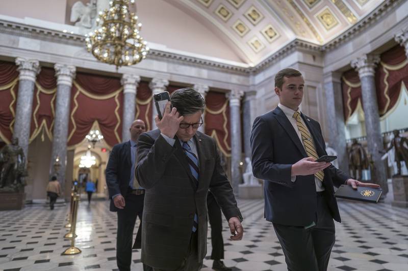 House Speaker Mike Johnson, R-La., walks through statuary Hall as lawmakers gather in the House chamber to vote on the articles of impeachment against Homeland Security Secretary Alejandro Mayorkas for failures on the U.S.- Mexico border at the Capitol in Washington, Tuesday, Feb. 6, 2024. The impeachment failed by one vote. (AP Photo/J. Scott Applewhite)