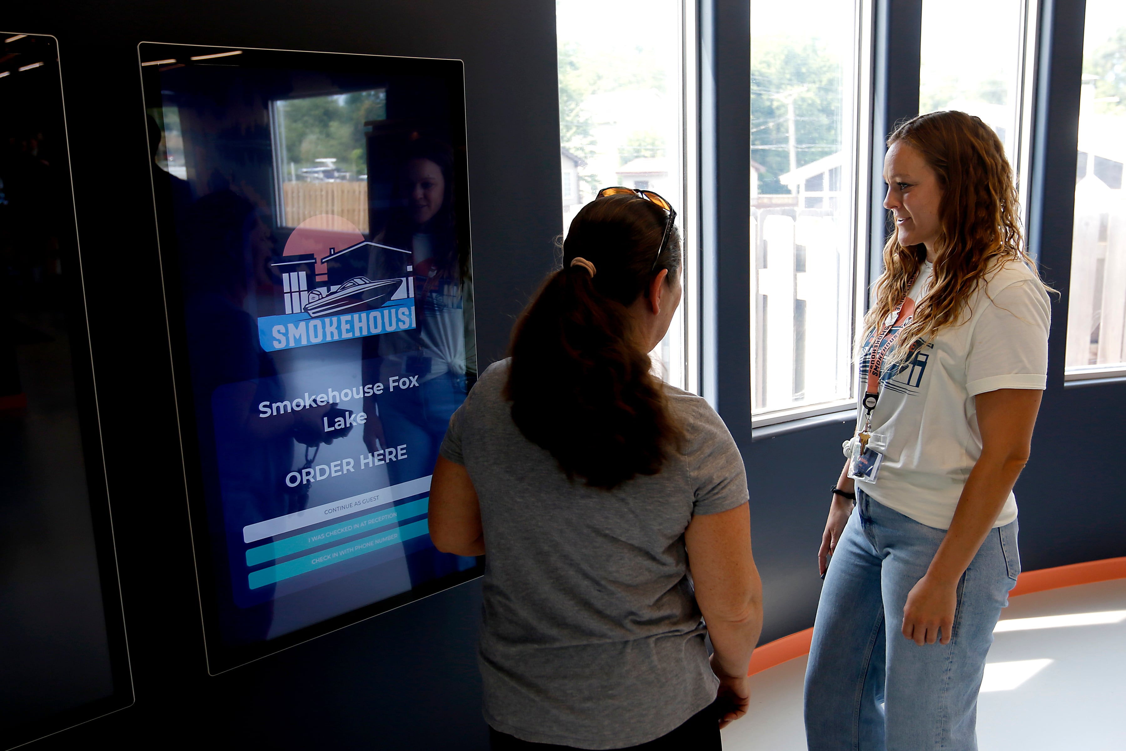 Smolehouse Agent in Charge Dennie Russ helps a customer at Illinois’ first dispensary located right on the water in Fox Lake on Friday, July 25,2024. The dispensary located at 44 U.S. Route 12, features boat slips so customers on the Fox River Chain of Lakes can boat right up to the dispensary.