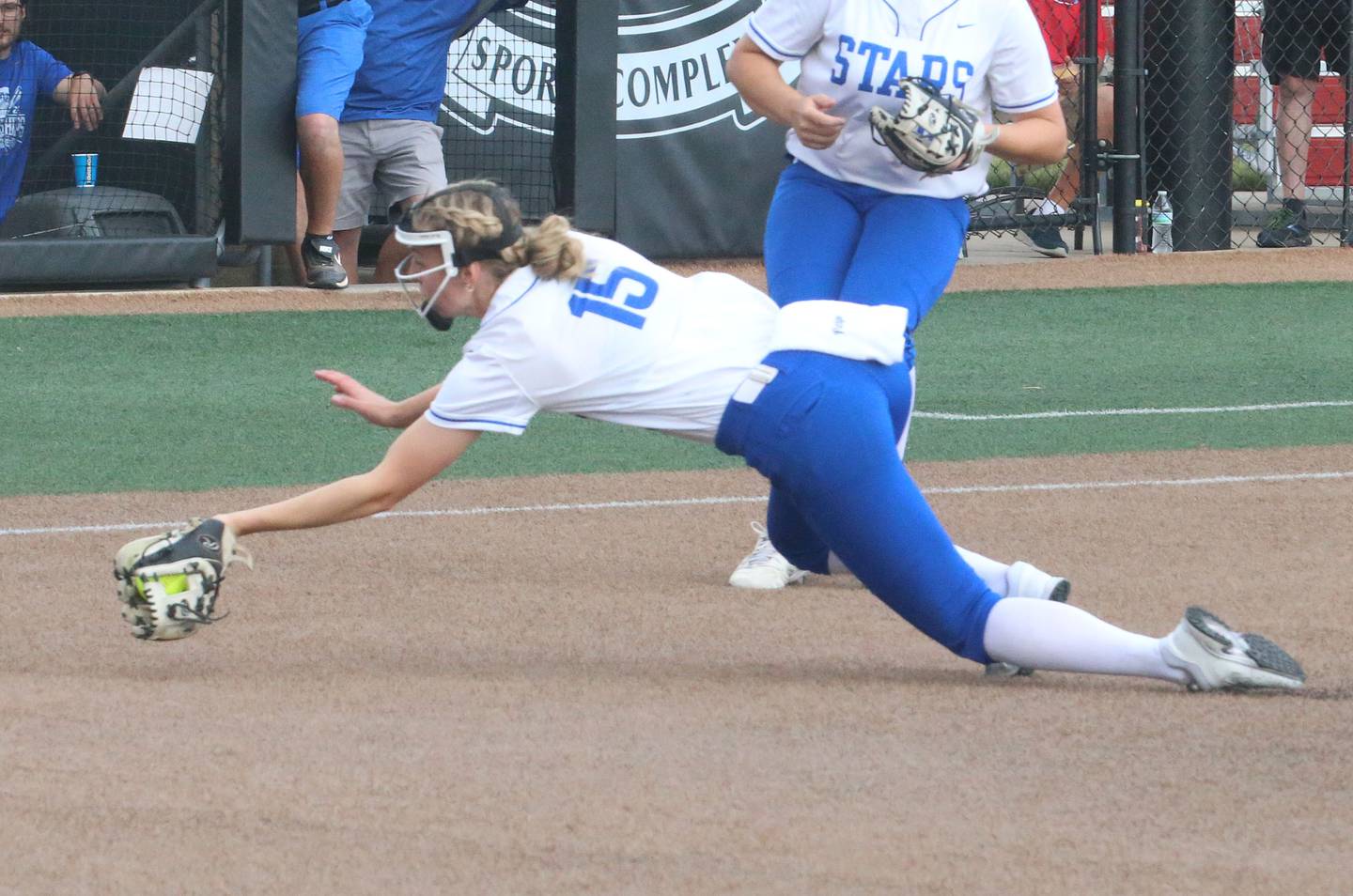 St. Charles North's Paige Murry makes a diving catch in front of home plate during the Class 4A championship game on Saturday, June 8, 2024 at the Louisville Slugger Sports Complex in Peoria.