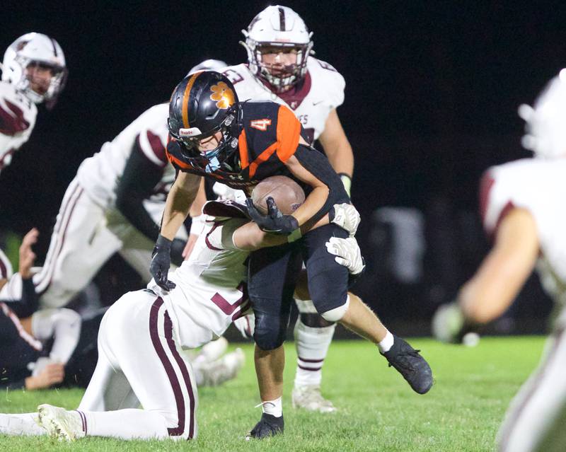 Crystal Lake Central's Carter Kelley looks to advance the ball against Prairie Ridge's defense on Friday, Oct.18, 2024 in Crystal Lake.