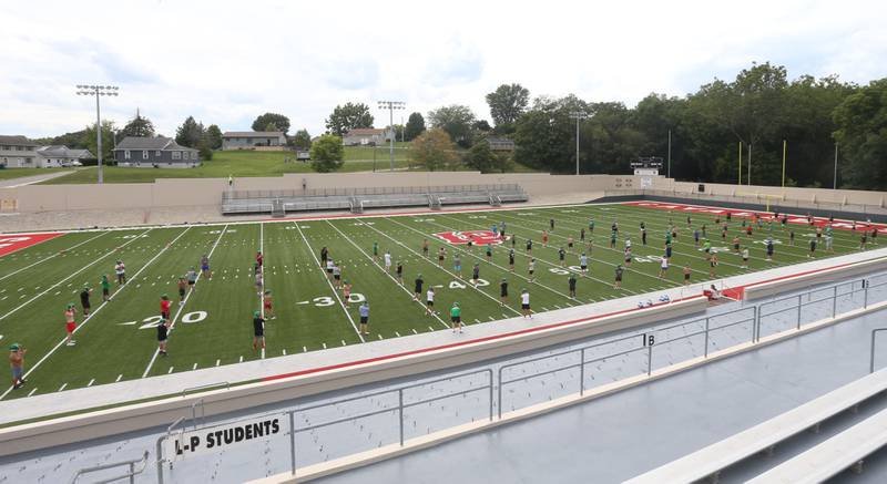 Members of the L-P football team stretch during the first day of football practice on Monday, Aug. 12, 2024 at Howard Fellows Stadium.