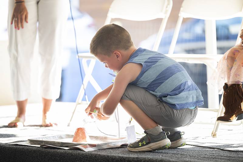 Caden Martz, 5, shows off his talent with a science experiment Thursday, June 13, 2024 for the Little Mister title at Polo’s Town and Country Days.