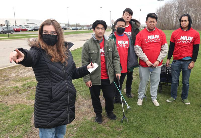 Katherine Albano, (left) a Northern Illinois University graduate student from Elburn, sends volunteers from NIU Cares to areas that need trash picked up Friday, April 29, 2022, on campus near the West Lagoon. NIU Cares, with the help of the Trash Squirrels, was taking part in a community cleanup event, going to several locations in DeKalb to pick up trash.