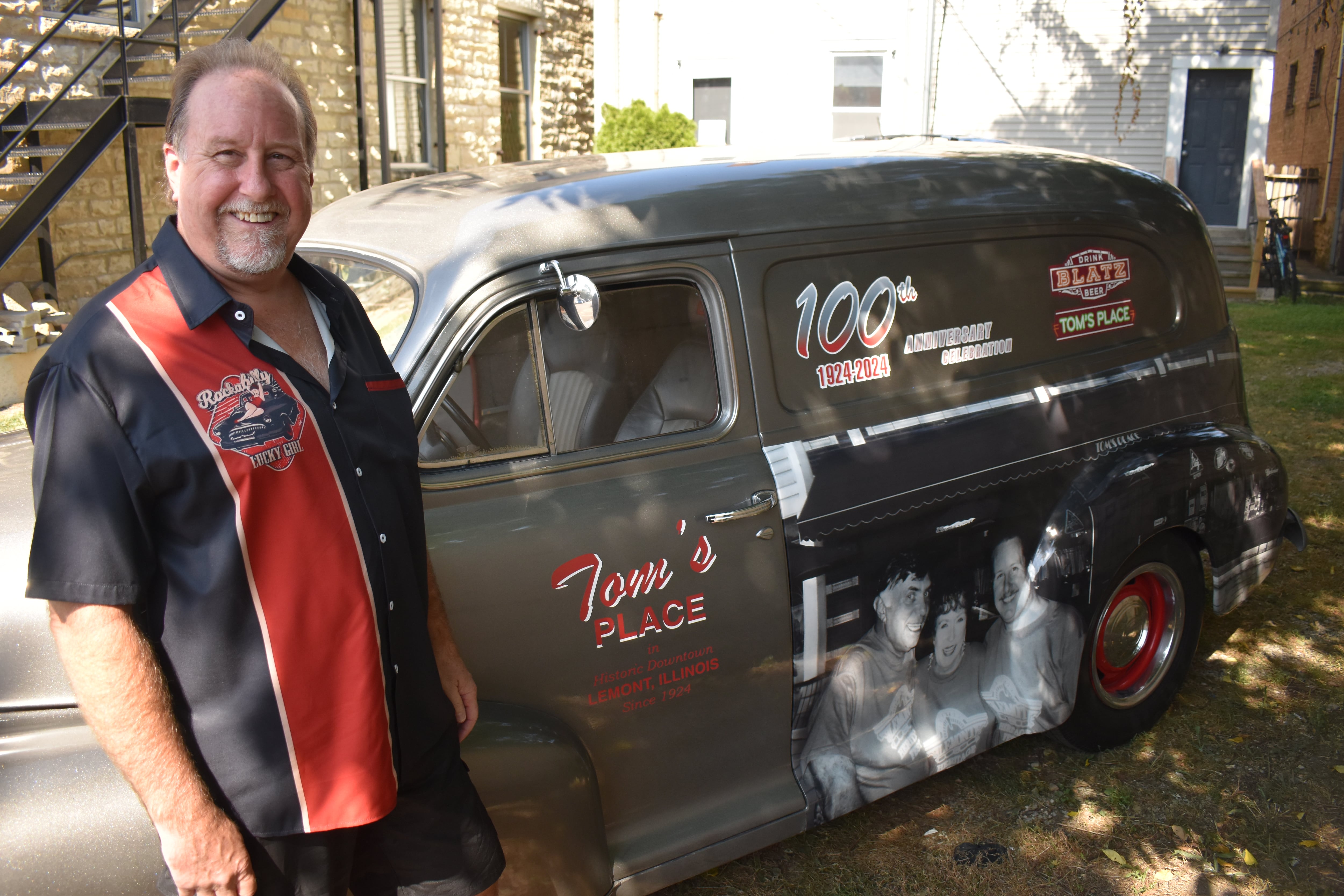 Tom Laketa decorated his 1948 Chevy delivery sedan to tout the 100th year of the family business. His father and mother, Milan and Elaine, are pictured with him.