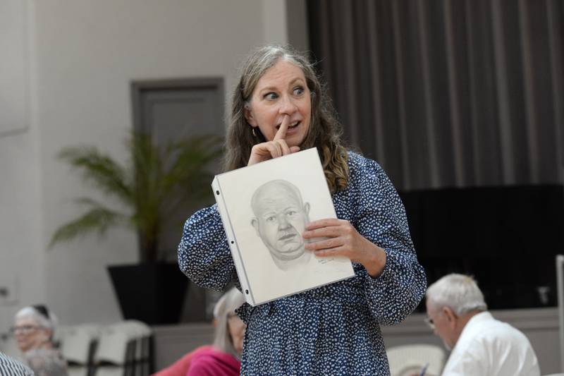 Retired forensic artist Bethe Hughes of Dixon points to her nose as she talks about how to draw suspects during a workshop on forensic art at the Coliseum Museum of Art, Antiques, and Americana in Oregon on Saturday, Aug. 17, 2024. Hughes worked as a special agent for the Illinois State Police for 20 years before retiring.