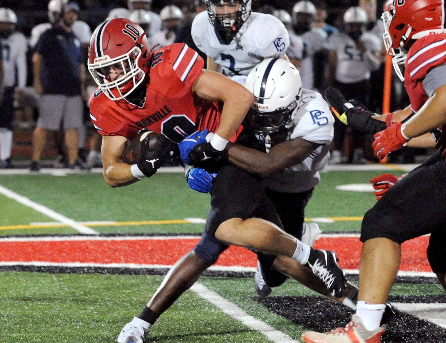 Yorkville running back Luke Zook (10) runs through a Plainfield South tackle on Friday, Sep. 30, 2024, at Yorkville High School.