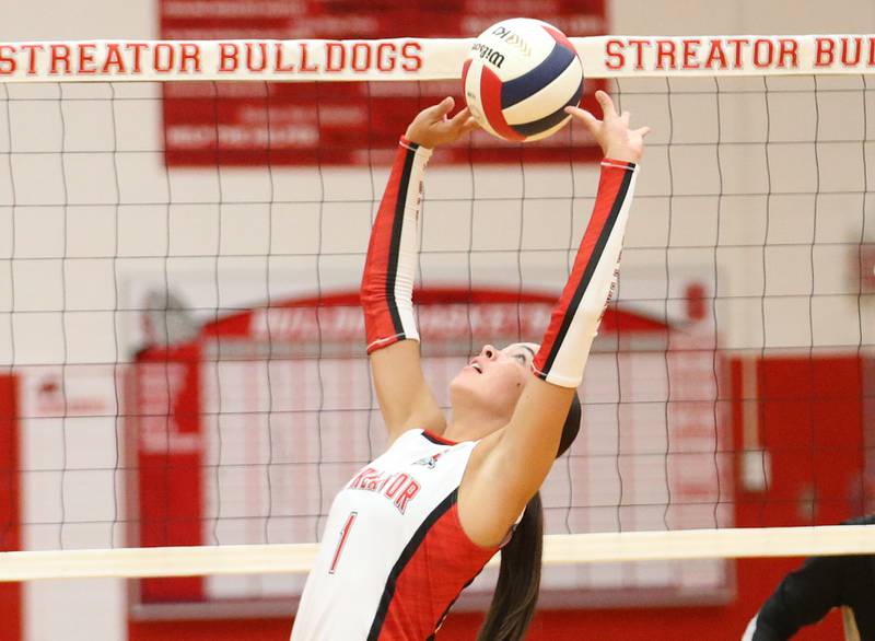 Streator's Aubrey Jacobs sets the ball in the air against Woodland on Monday, Aug. 26, 2024 at Streator High School.