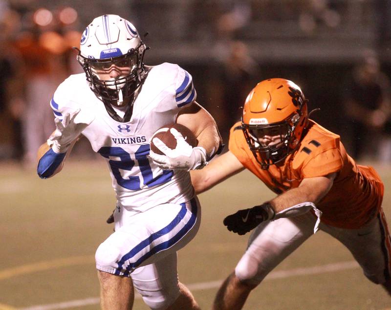 Geneva’s Michael Rumoro runs the ball as he’s chased down by Wheaton Warrenville South’s Zach Rogers during a game Friday, Sept. 13, 2024 in Wheaton.