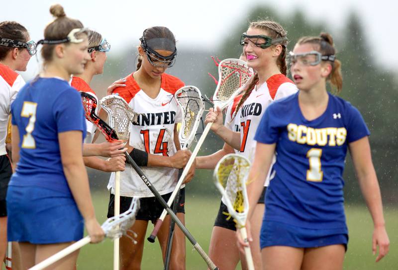 Crystal Lake Central players gather around Addison Bechler (14) after her second goal against Lake Forest during girls lacrosse supersectional action at Metcalf Field on the campus of Crystal Lake Central Tuesday.