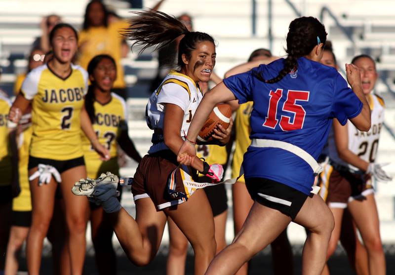 Jacobs’ Brie Verburg runs the ball in varsity flag football on Tuesday, Sept. 3, 2024, at Dundee-Crown High School in Carpentersville.