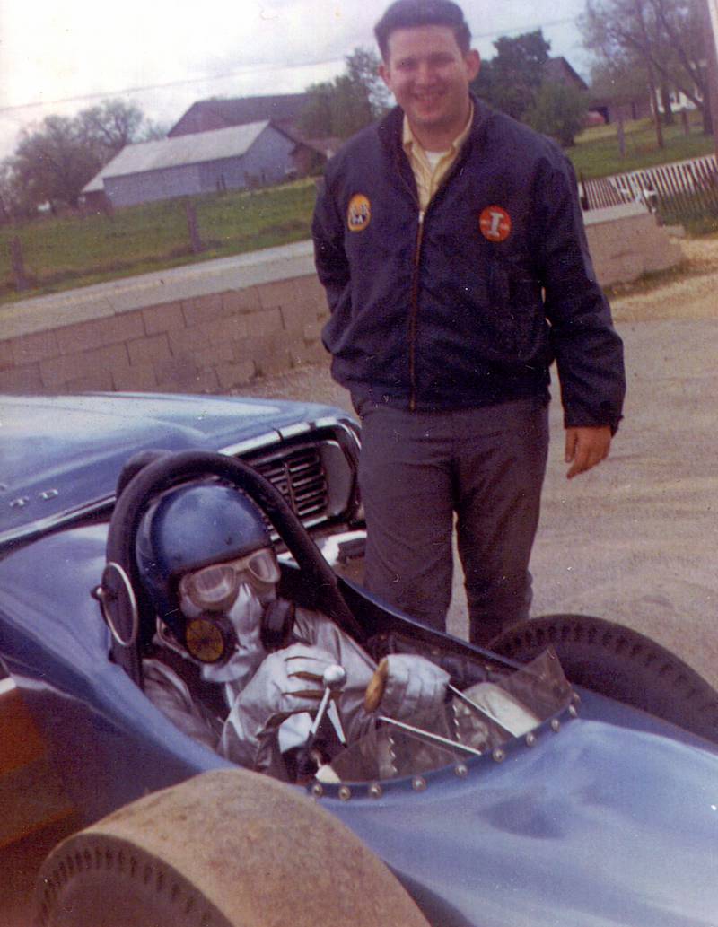 Bob Mead of Oswego, wearing a helmet and Nomex suit, sits at the controls of the dragster he and Jerry Swanson (standing beside him) built, as they prepare for a 1969 race at the Oswego Drag Raceway. Information on Mead and other dragsters from the Oswego Drag Raceway will be available at the Little White School Museum’s current temporary exhibit, “SUNDAY! SUNDAY! SUNDAY!” which will run through September.