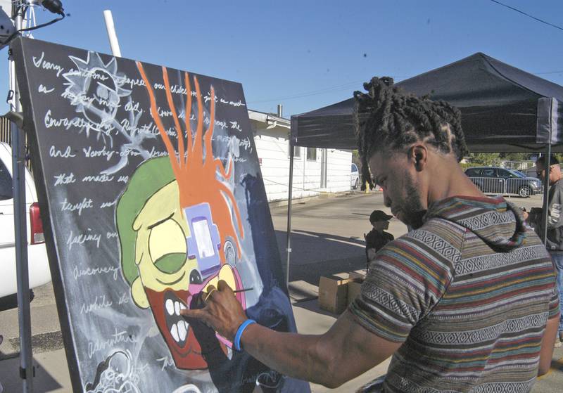 Pharaoh Kemet (Aaron Harts of Sterling) works on a painting at the Dement Town Music Fest. The fest, presented by Discover Dixon was held on Saturday, Sept. 7, 2024