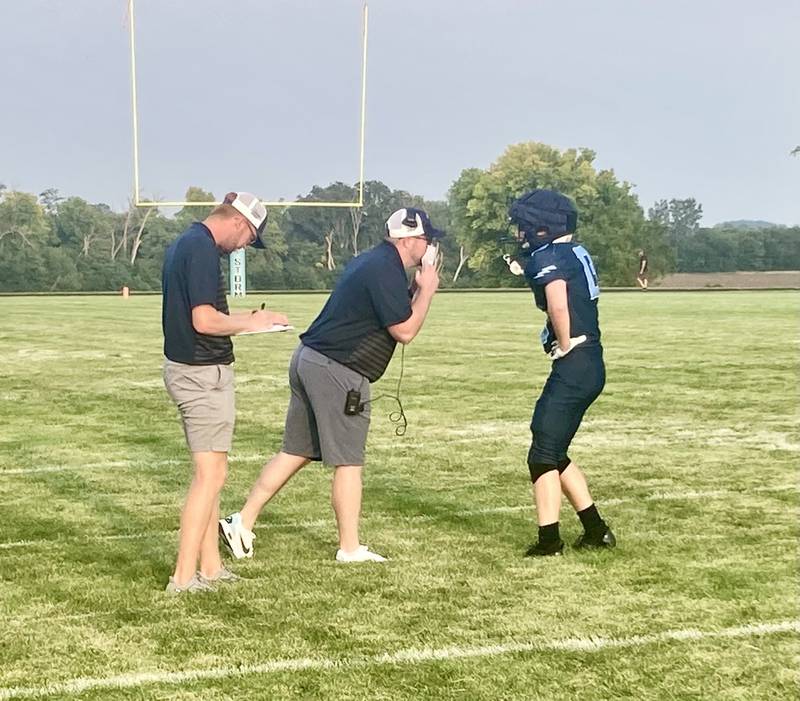 Bureau Valley coach Mat Pistole tells Storm quarterback Bryce Helms the play call during Saturday's Week 0 scrimmage vs. E-P. Both teams