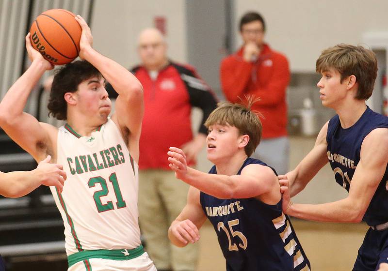 L-P's Josh Senica is guarded by Marquette's Peter McGrath and teammate Charlie Mullen during the 49th annual Colmone Classic Tournament on Wednesday, Dec. 6, 2023 at Hall High School.