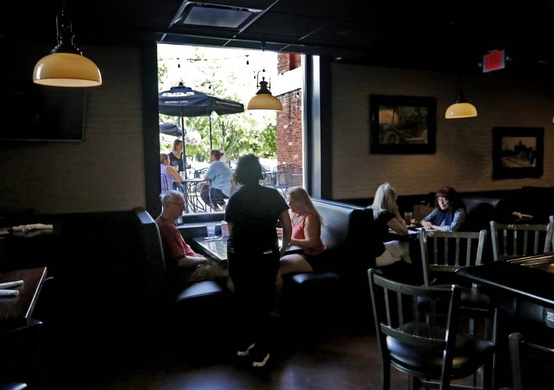 People dine inside and outside Tuesday, Aug. 29, 2023, at the Public House of Woodstock. The restaurant recently reopened after the newly remodeled Old Courthouse and Sheriff's House opened.