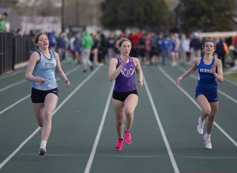 Bureau Valley’s Kate Salisbury (left), Dixon’s Kaitlyn Daniels and Newman’s Helen Papoccia 100 meter dash Friday, April 21, 2023 at the Rock Falls Rocket Invitational.