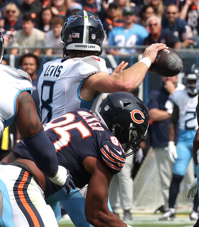 Chicago Bears defensive end DeMarcus Walker hits Tennessee Titans quarterback Will Levis as he throws during their game Sunday, Sept. 8, 2024, at Soldier Field in Chicago.