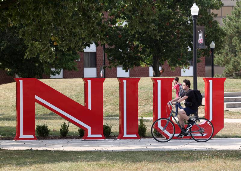 A Northern Illinois University students bikes past the NIU sculpture Thursday, Sept. 12, 2024, on campus at NIU in DeKalb.