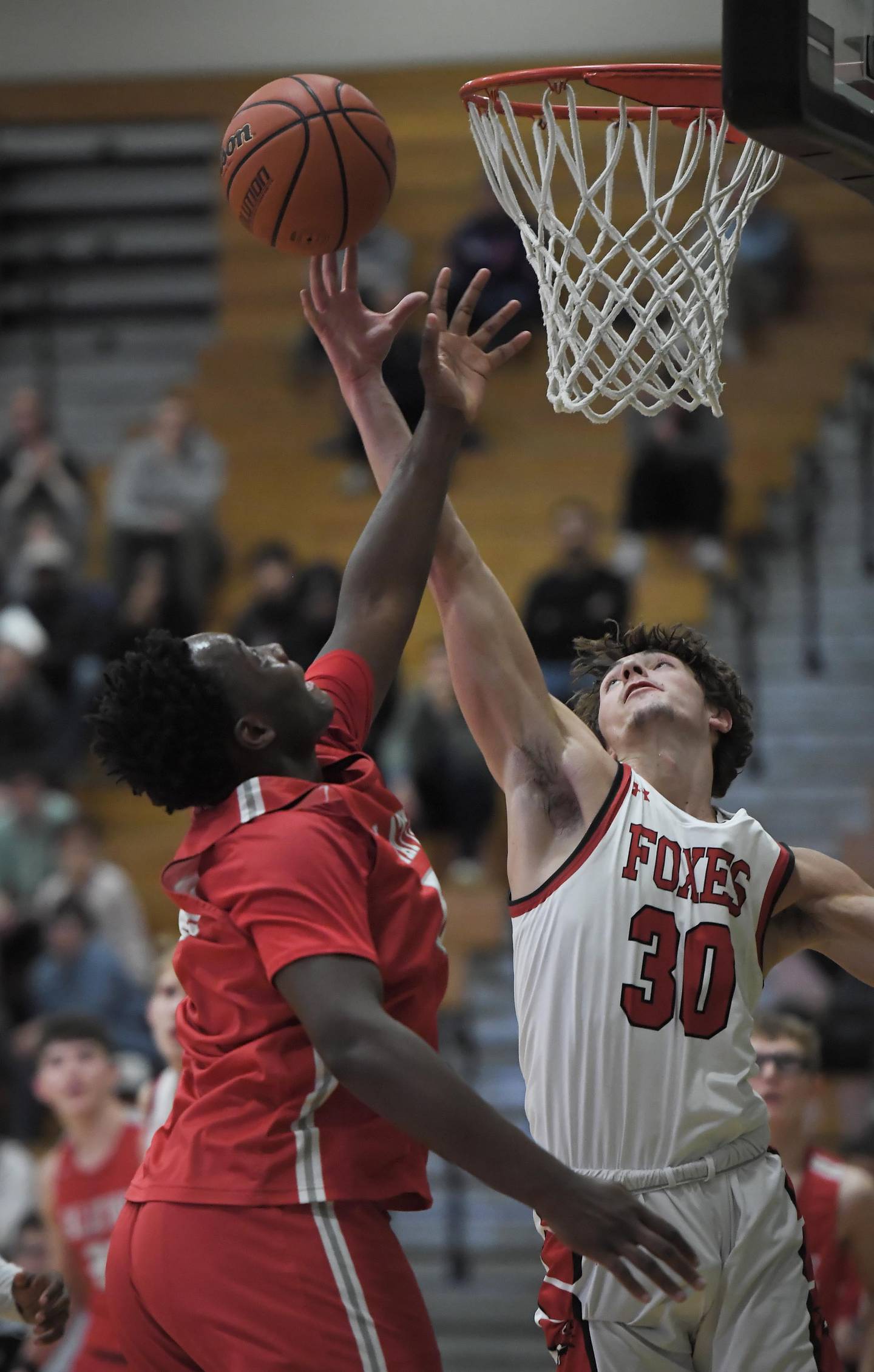 Palatine’s Tony Balanganayi and Yorkville’s Bryce Salek, right, stretch for a rebound in a quarterfinal game of the Jack Tosh Classic at York High School in Elmhurst on Thursday, Dec. 28, 2023.