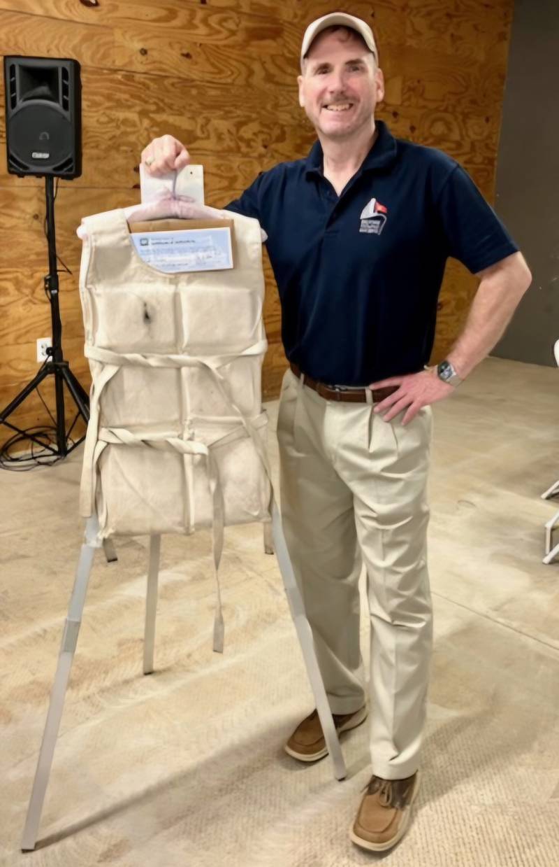 Historian Peter Cook displays a life vest recovered from the 1912 sinking of the Titanic following his lecture at the Bureau County History Center.