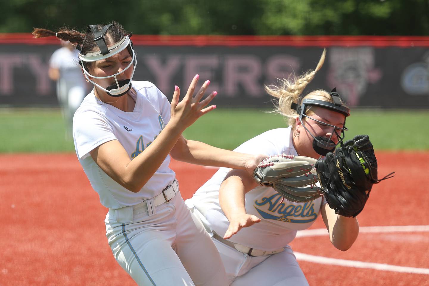 Joliet Catholic’s Nina Sebahar, left, collides with Addie Fanter after making a catch against Beecher in the Class 2A regional championship on Saturday, May 18, 2024 at Lewis University in Romeoville.