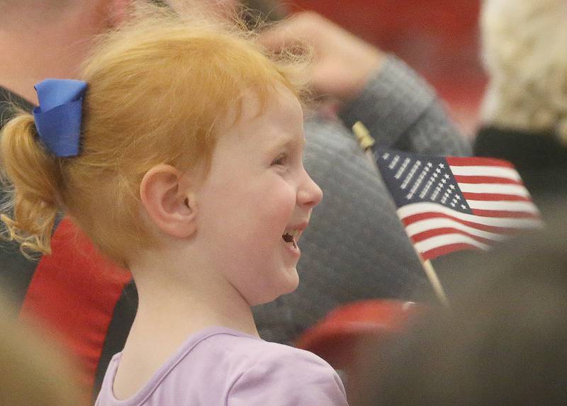 Seva Pinnegar 4, of Peru waves her American Flag while singing patriotic music during the Parkside School Veterans Day Program on Friday, Nov. 10, 2023 at Parkside Middle School in Peru.