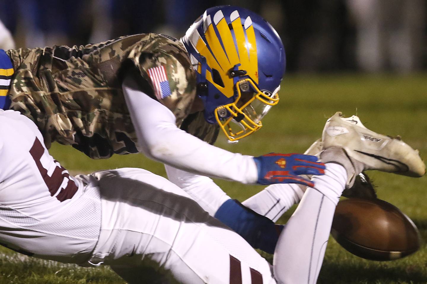 Johnsburg's Duke Mays tries to regain possession of the football after Richmond-Burton's Luke Rendtorff caused a fumble during a Kishwaukee River Conference football game on Friday, Oct.6, 2023, at Johnsburg High School.