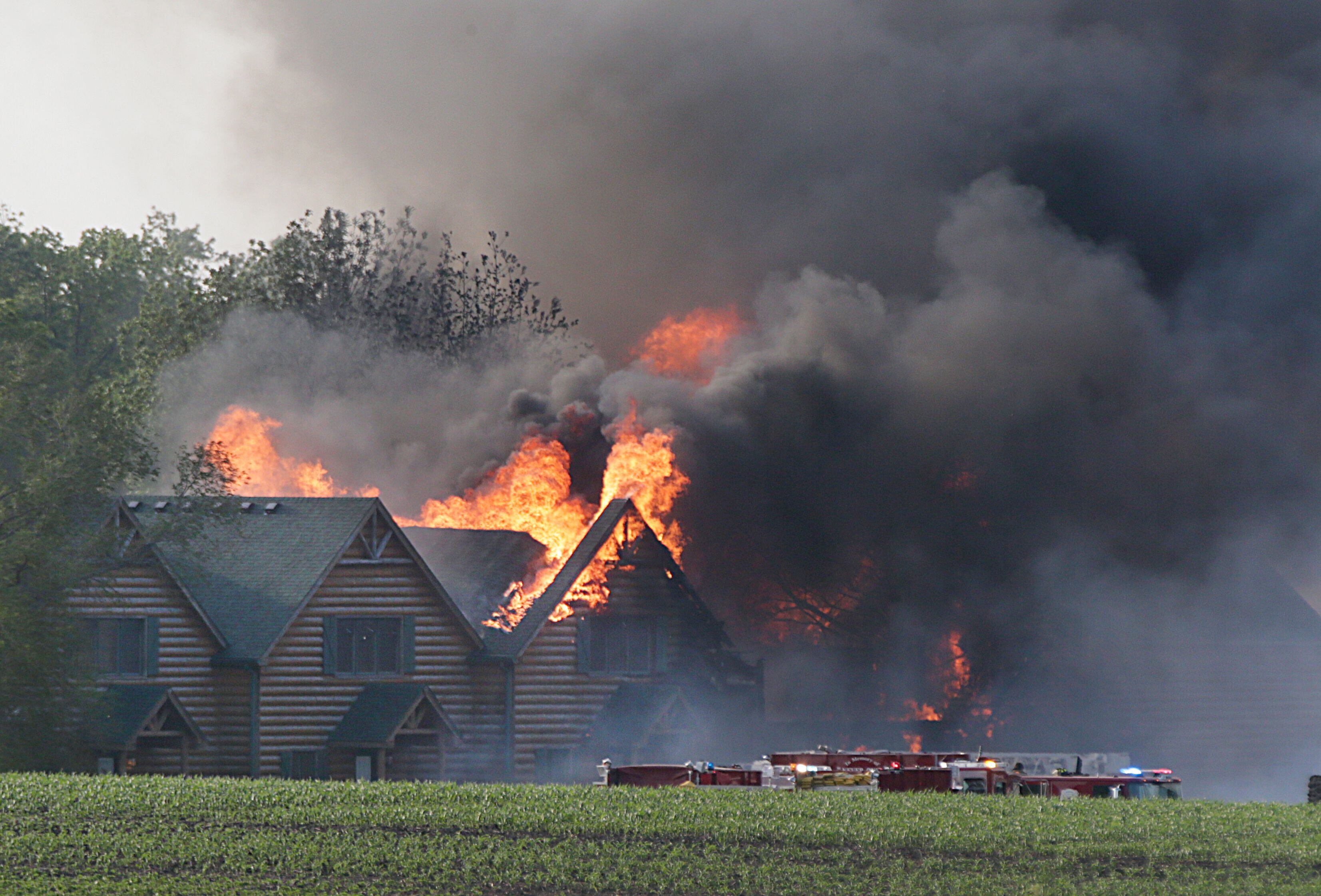 Large flames engulf several cabins at Grand Bear Resort on Monday, May 30, 2022. High winds made it extremely difficult for firefighters to battle the flames. 