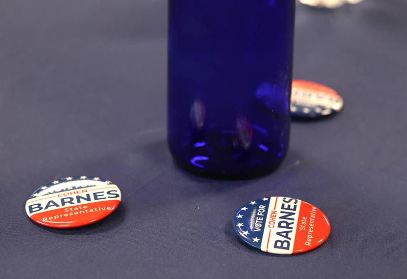 Buttons and flags adorn the tables Tuesday, March 19, 2024,  at Faranda’s in DeKalb during the election night party for Cohen Barnes, DeKalb mayor and candidate for the democratic nomination for the 76th district seat in the Illinois House of Representatives.