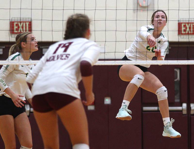 Crystal Lake South’s Morgan Johnson lands after slamming the ball over the net in varsity girls volleyball on Thursday, Aug. 29, 2024, at Prairie Ridge High School in Crystal Lake.