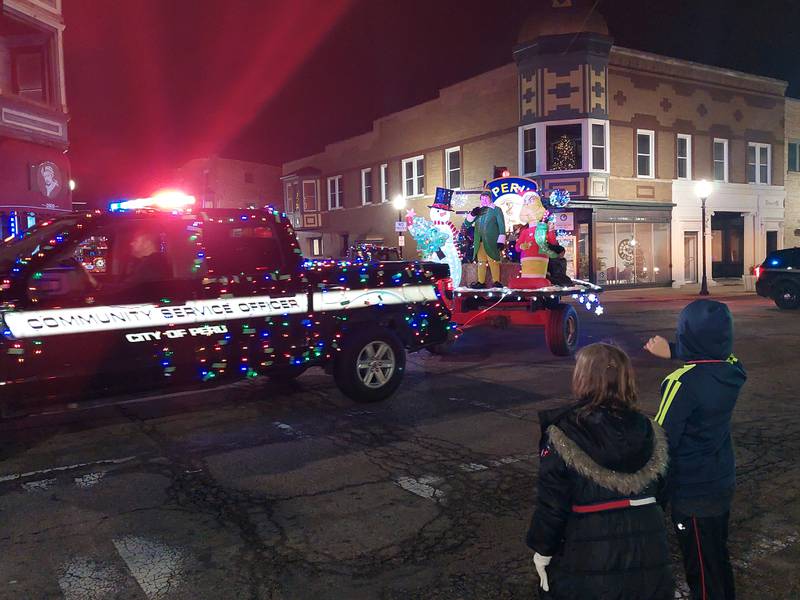 An elf rides on the Peru Police Department float Saturday, Dec. 2, 2023, during the Lighted Christmas Parade in Peru.