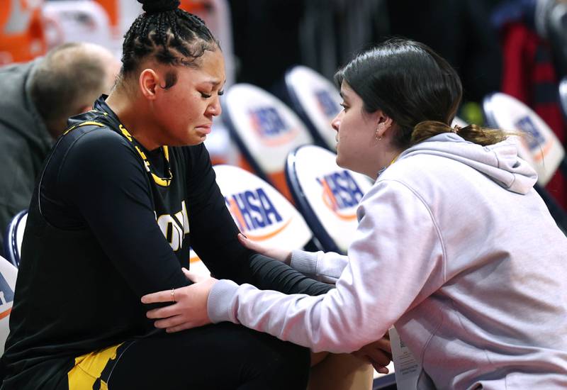 Hinsdale South's Amerie Flowers is consoled after her teams loss to Glenwood during their game Friday, March 1, 2024, in the IHSA Class 3A state semifinal at the CEFCU Arena at Illinois State University in Normal.