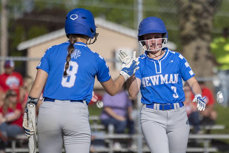 Newman’s Addison Foster (right) celebrates the Comets’ first run with teammate Lucy Oetting Friday, May 3, 2024 against Morrison.