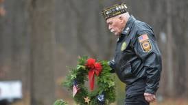 Dedicated volunteers honor veterans in the rain during Wreaths Across America