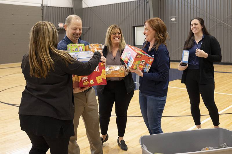 Dixon Park District director Duane Long is loaded up with donated food items for a picture Thursday, Jan. 25, 2024.