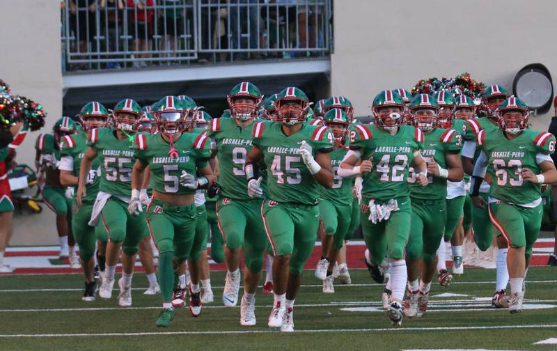 Members of the L-P football team run onto the field before playing Ottawa on Friday, Sept. 13, 2024 at Howard Fellows Stadium.